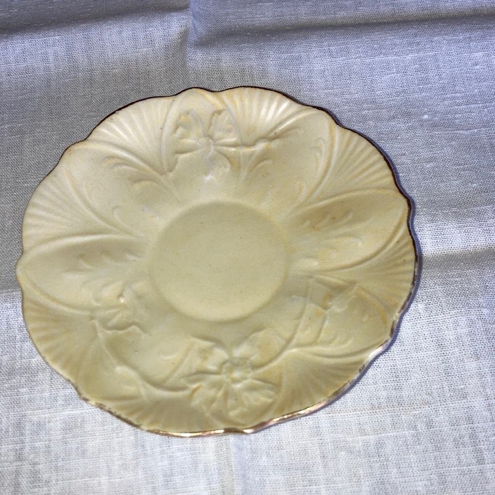 Demi-tas saucer 4 1/2” dia.  Yellow open rose in starburst pattern. $9